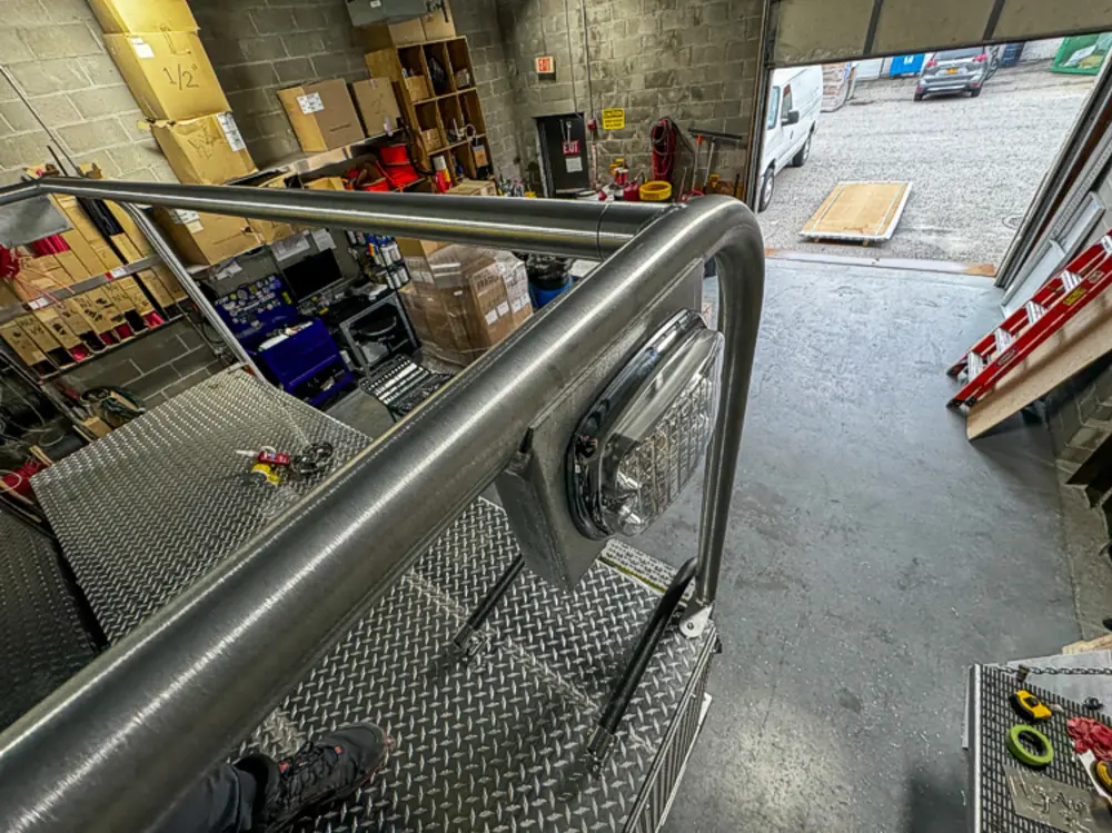 Diamond-plate body and step detail in production, photo 58 of 303.